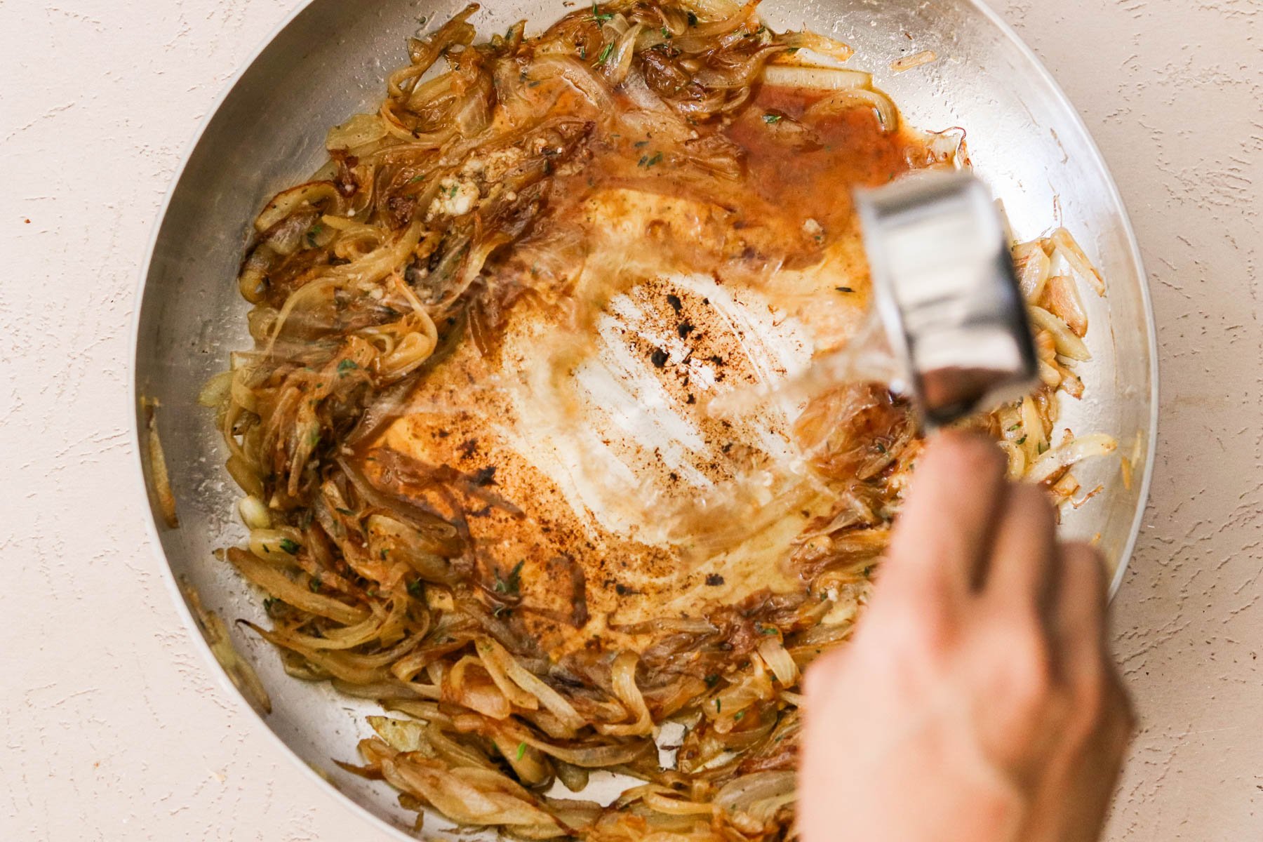 Deglazing caramelized onions with white wine and Dijon.