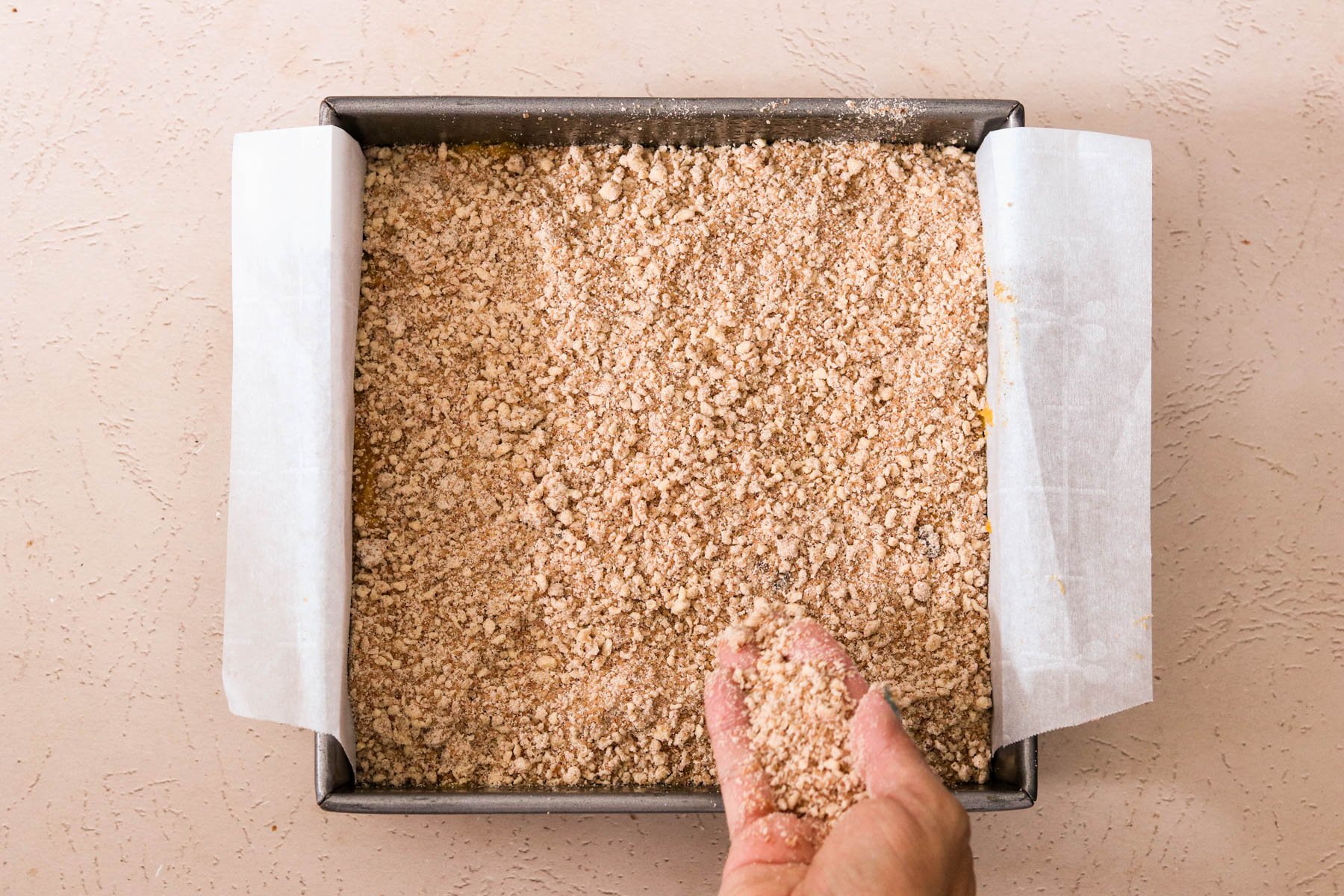 Cinnamon crumb topping sprinkled evenly over batter before baking.