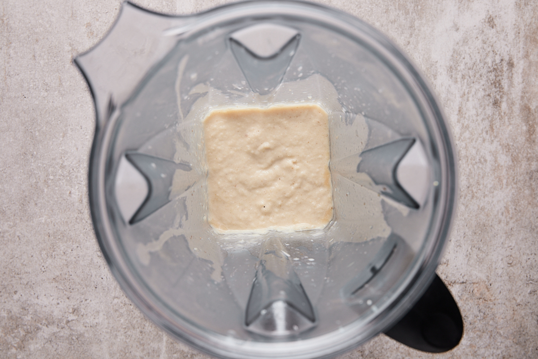 Blended cauliflower mixture in a blender, showing a smooth and creamy consistency.”