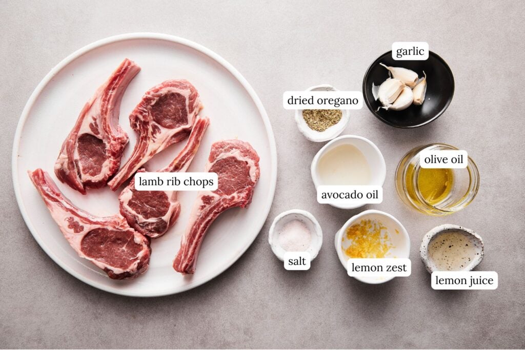 ingredients for lamb chops including raw lamb, seasonings, and oil.