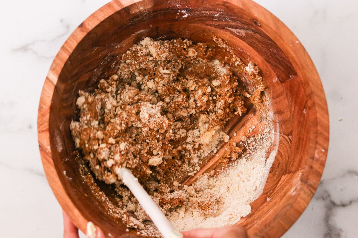 Mixing the wet ingredients into the dry ingredient bowl.