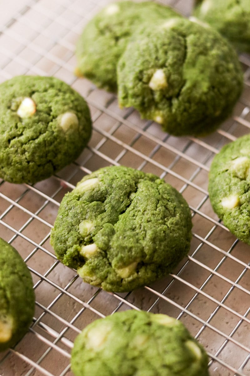 Close-up of matcha chocolate chip cookies on a cooling rack.