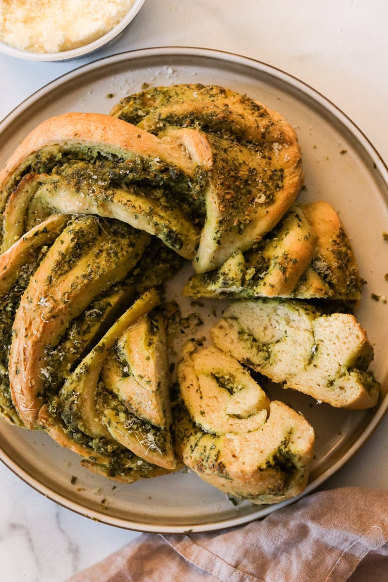 the baked wreath bread with pesto on a plate