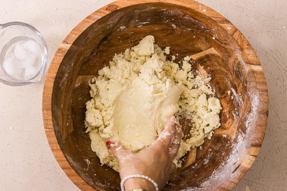 Ice water added to gluten-free dough and gently mixed until the dough holds together.