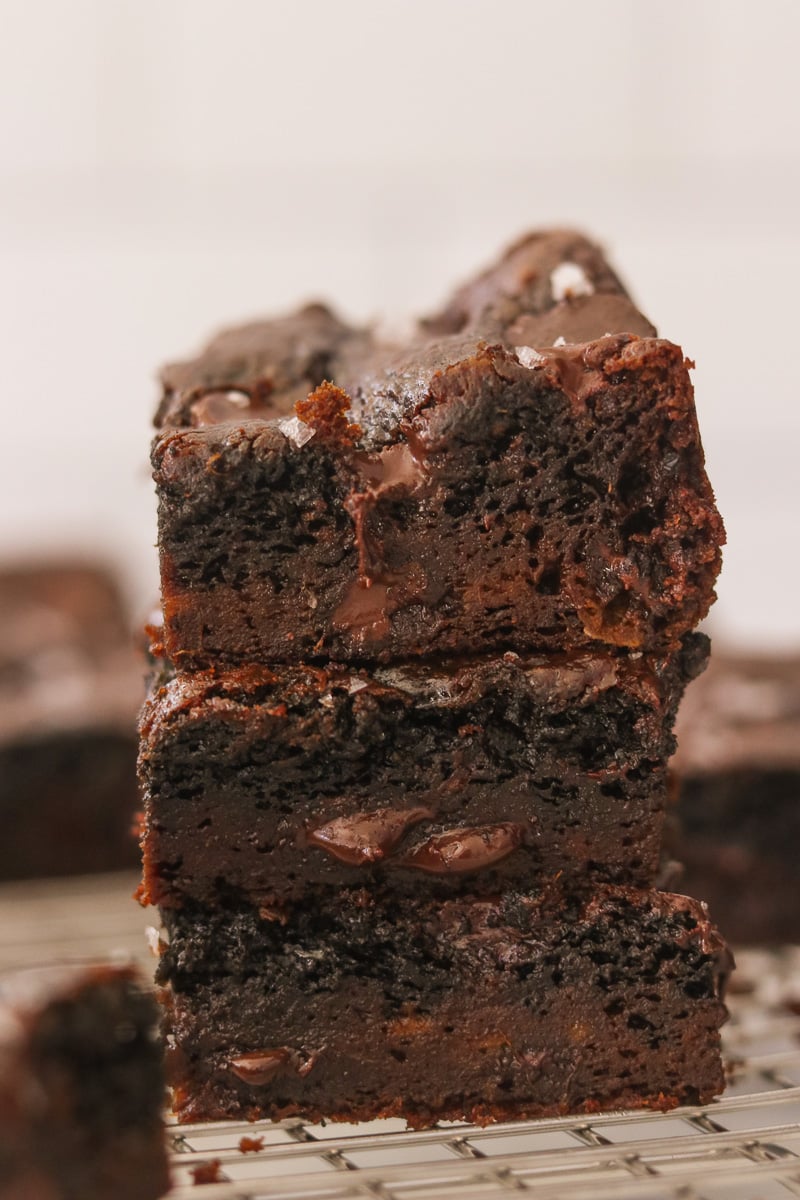 Close-up of 3 stacked sweet potato brownies showing their fudgy, gooey texture.