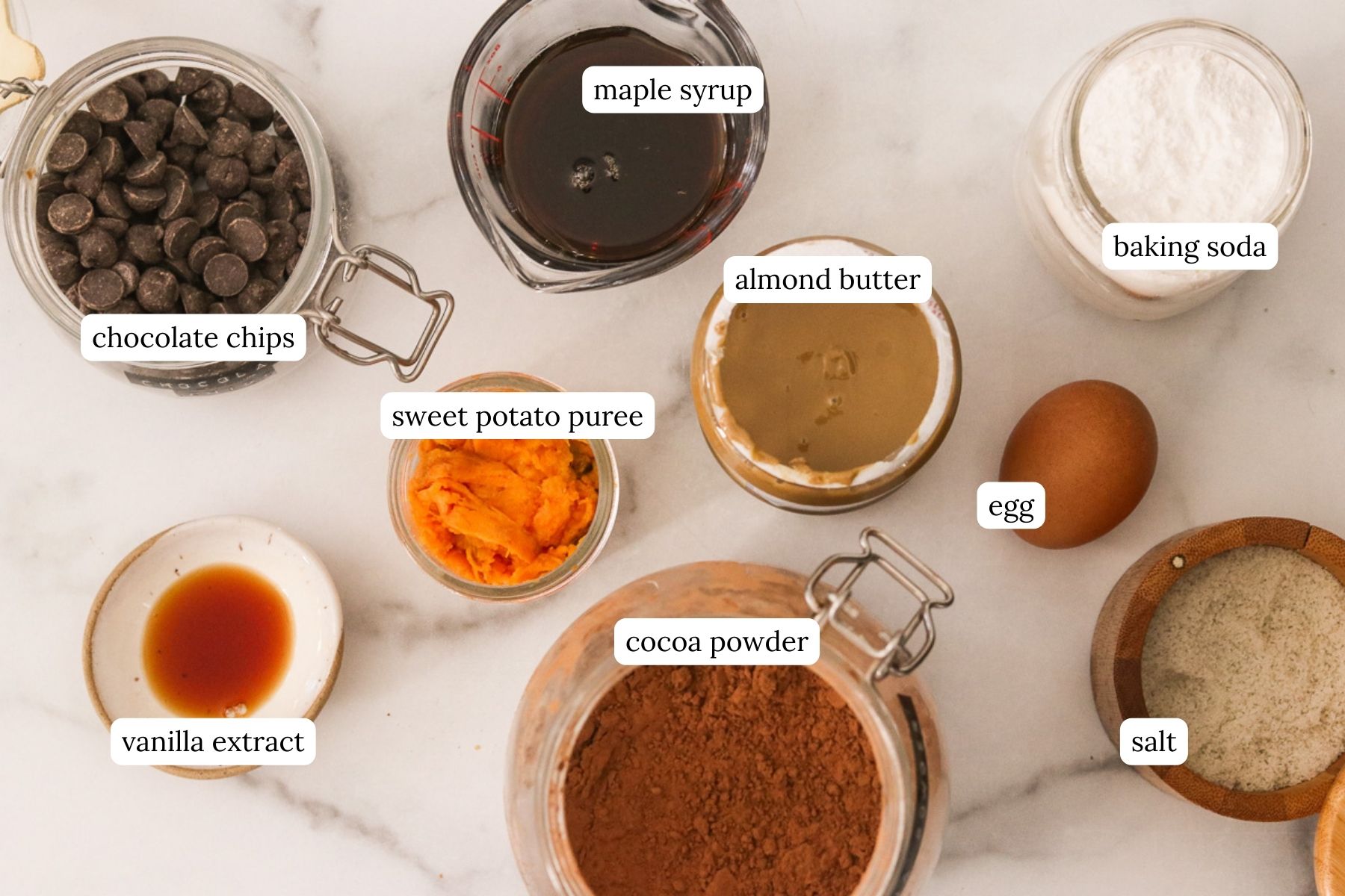 Sweet potato brownies recipe ingredients laid out and labeled on a white countertop.