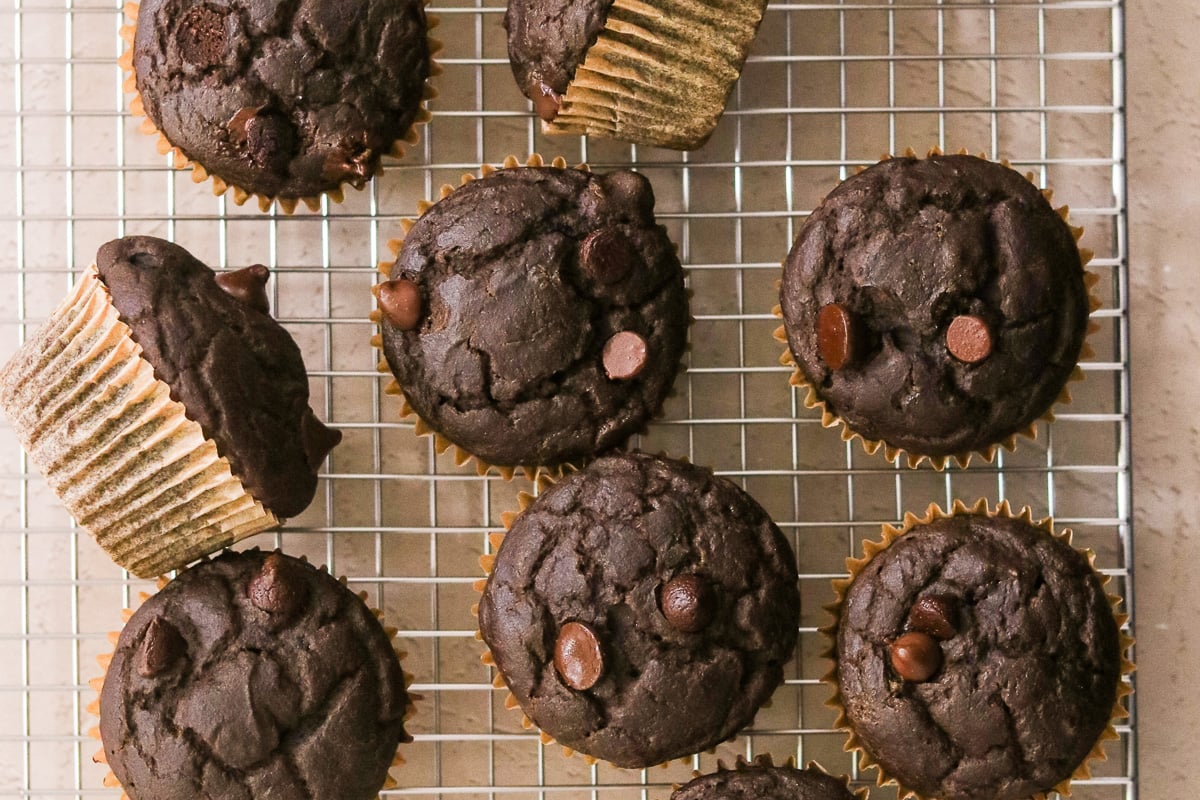 Freshly baked hidden veggie chocolate muffins cooling on a wire cooling rack.