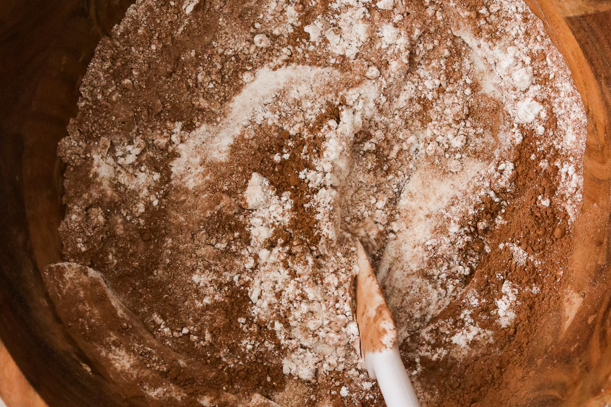 Dry ingredients for hidden veggie chocolate muffins whisked together in a mixing bowl.