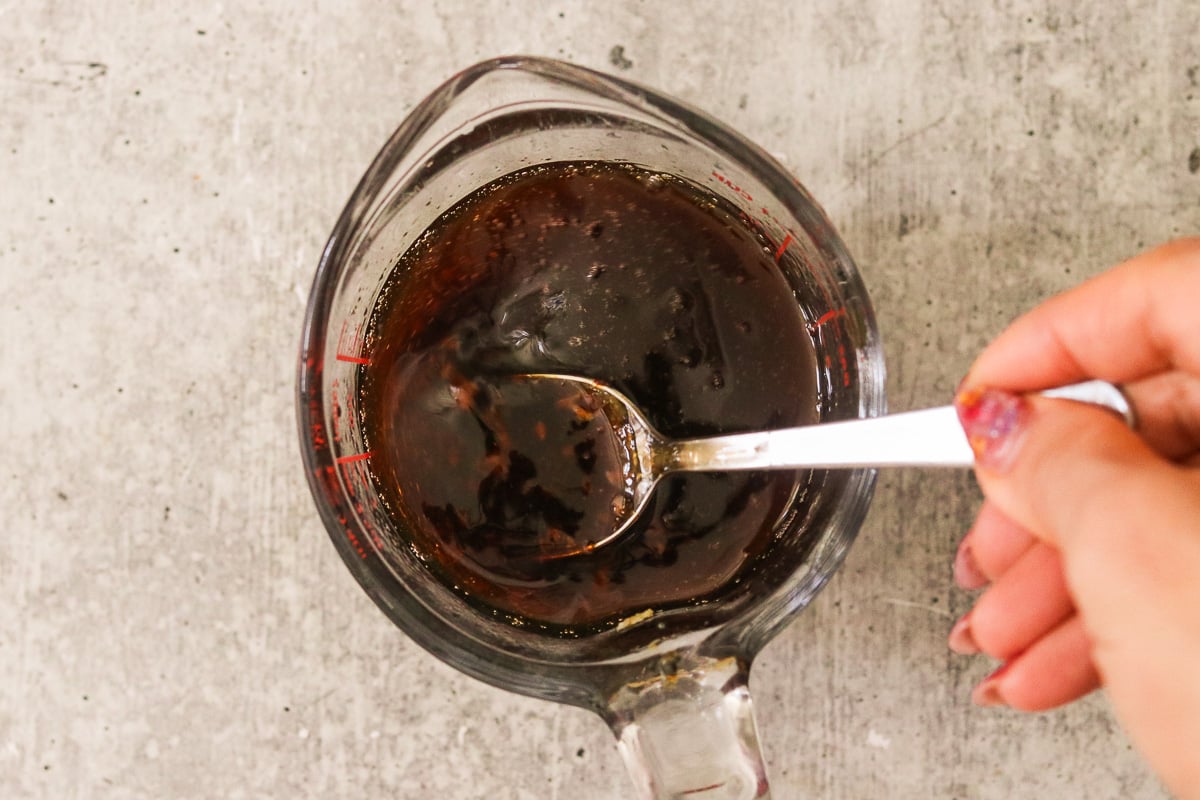 Tamari, toasted sesame oil, rice vinegar, sugar, lime juice, garlic, and chili whisked together in a bowl.