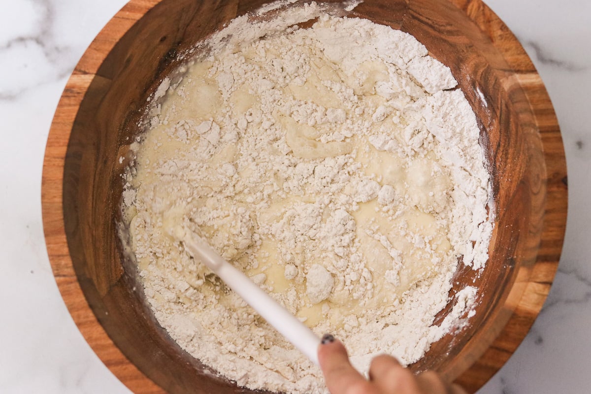 Combining wet and dry ingredients to make funnel cake batter.