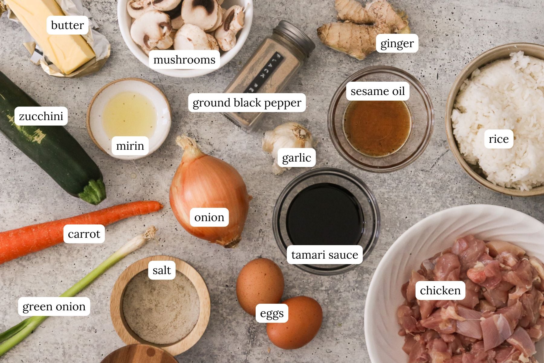 Hibachi chicken bowl recipe ingredients labeled and arranged on a light gray countertop.