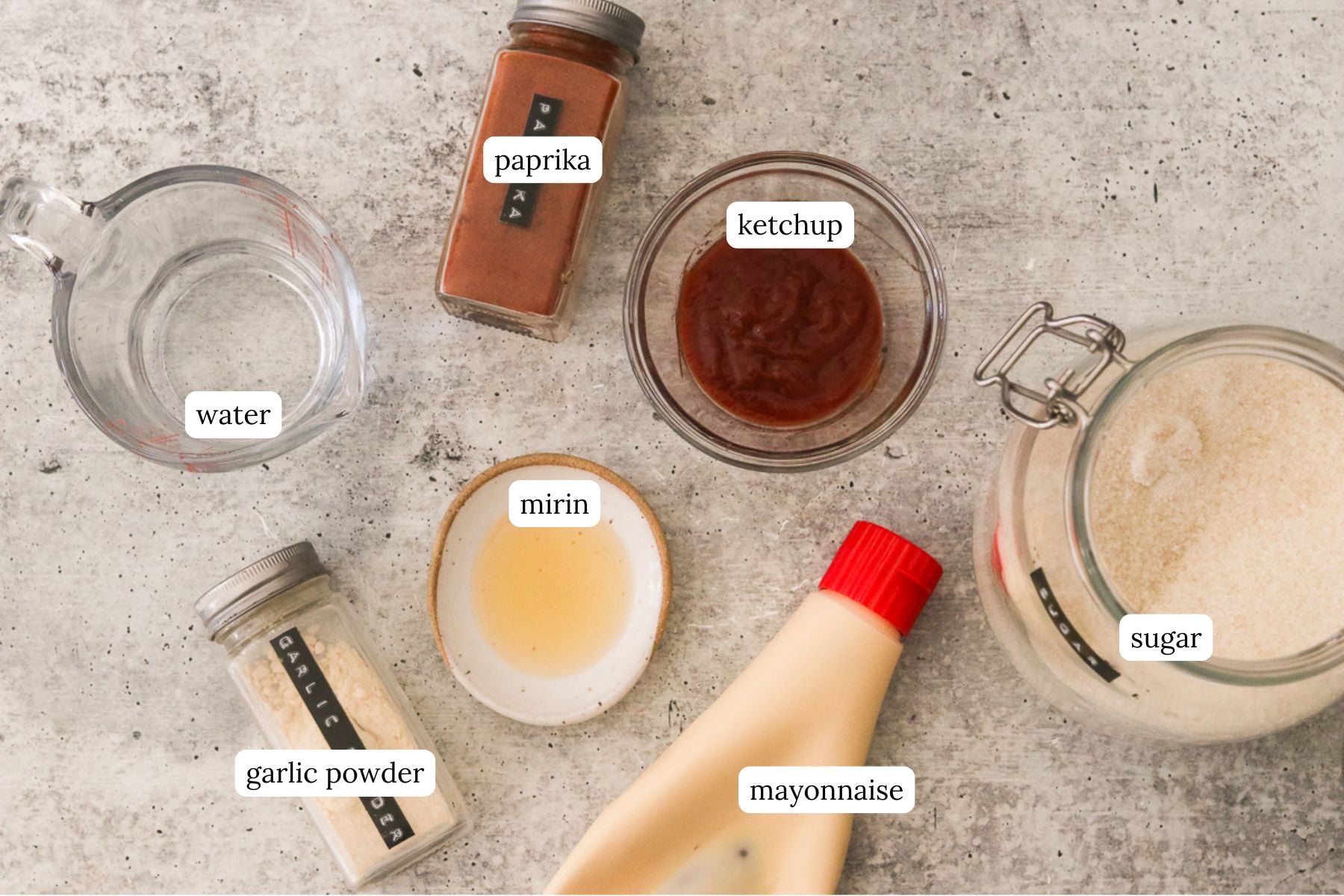 Yum yum sauce ingredients labeled and arranged on a light gray countertop.