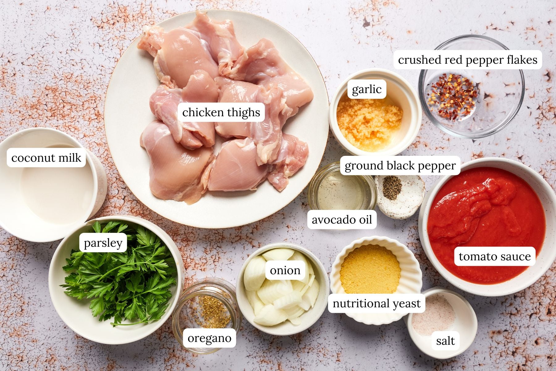 Creamy tomato chicken recipe ingredients labeled and laid out on a countertop.