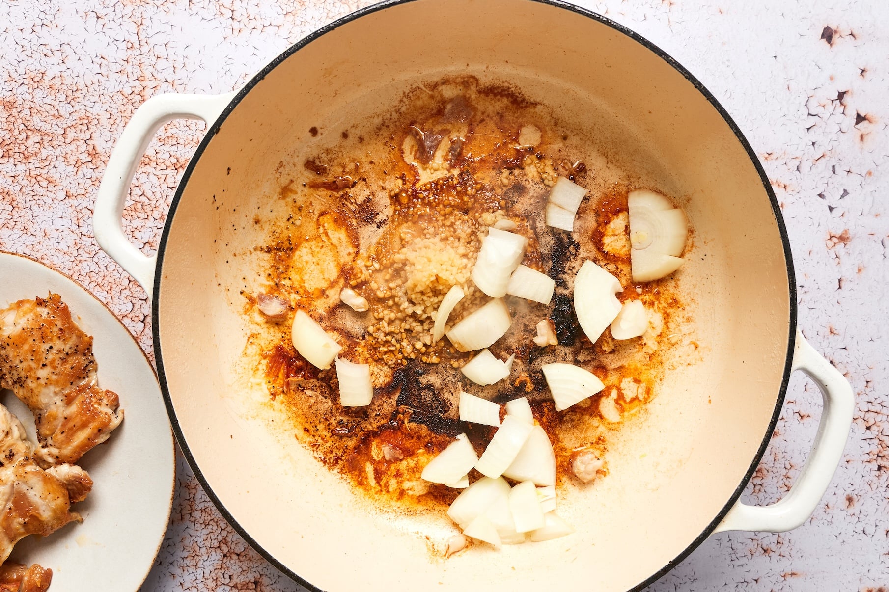 Chopped onion and garlic cooking in the skillet until soft and translucent.