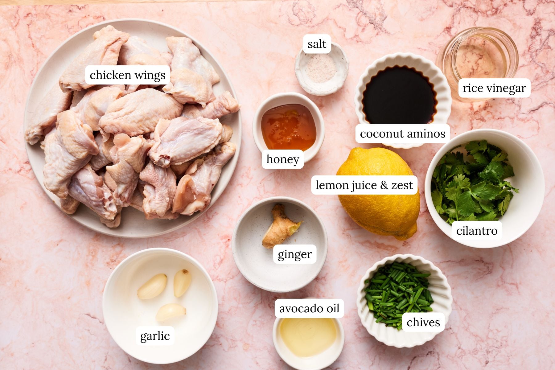 Paleo chicken wings recipe ingredients laid out in nesting bowls and labeled.