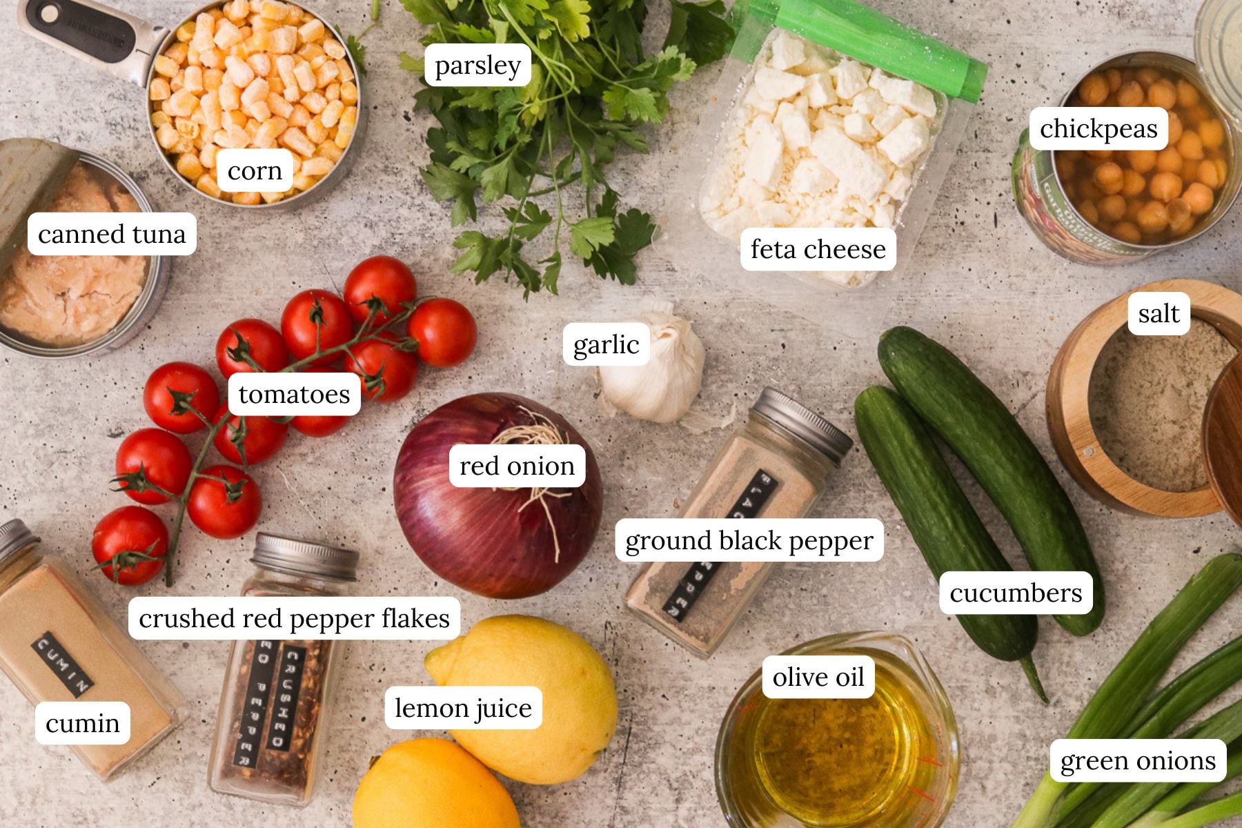 Chickpea tuna salad recipe ingredients labeled and laid out on a countertop.