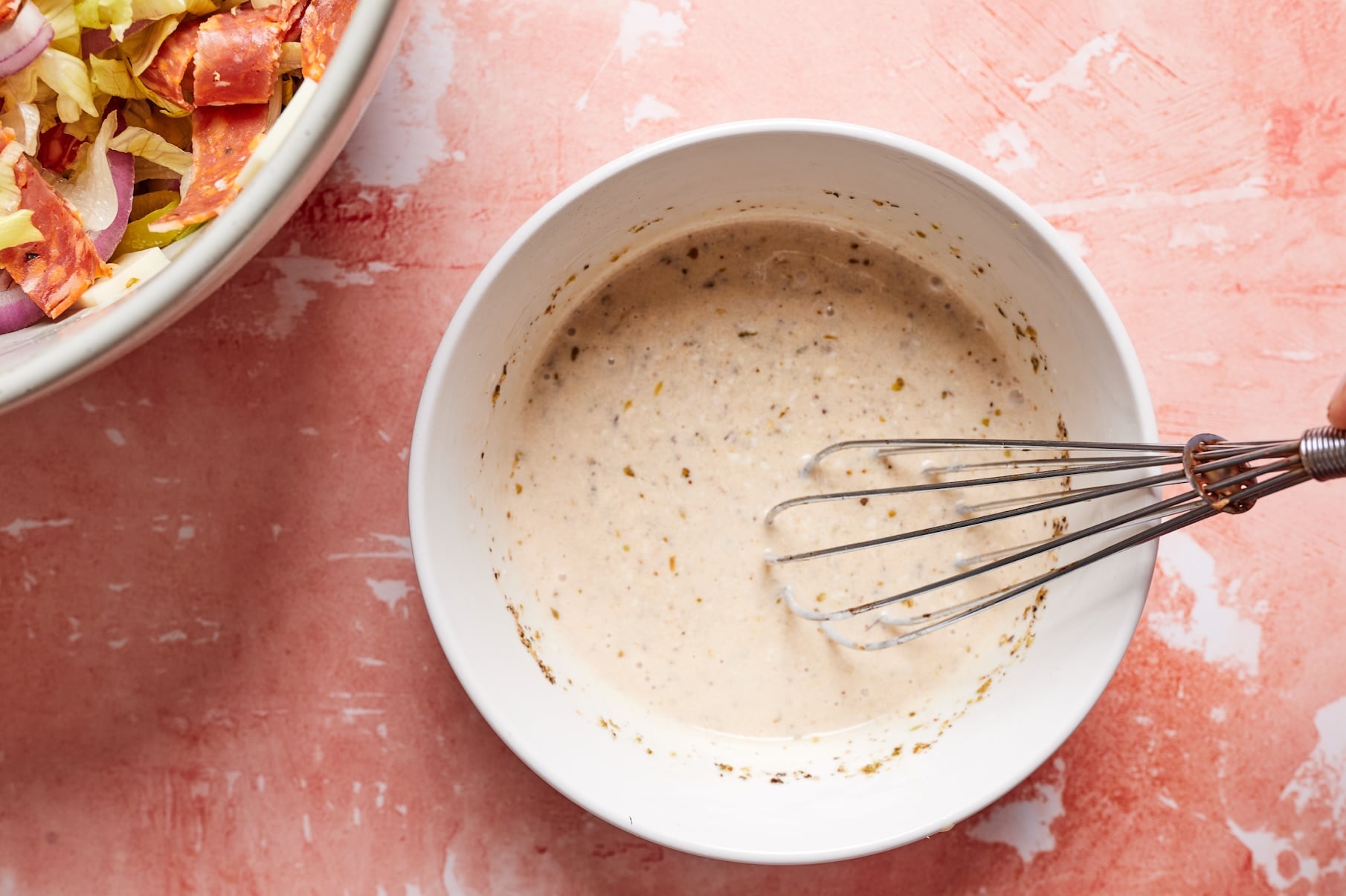 Dressing ingredients whisked together in a small bowl.