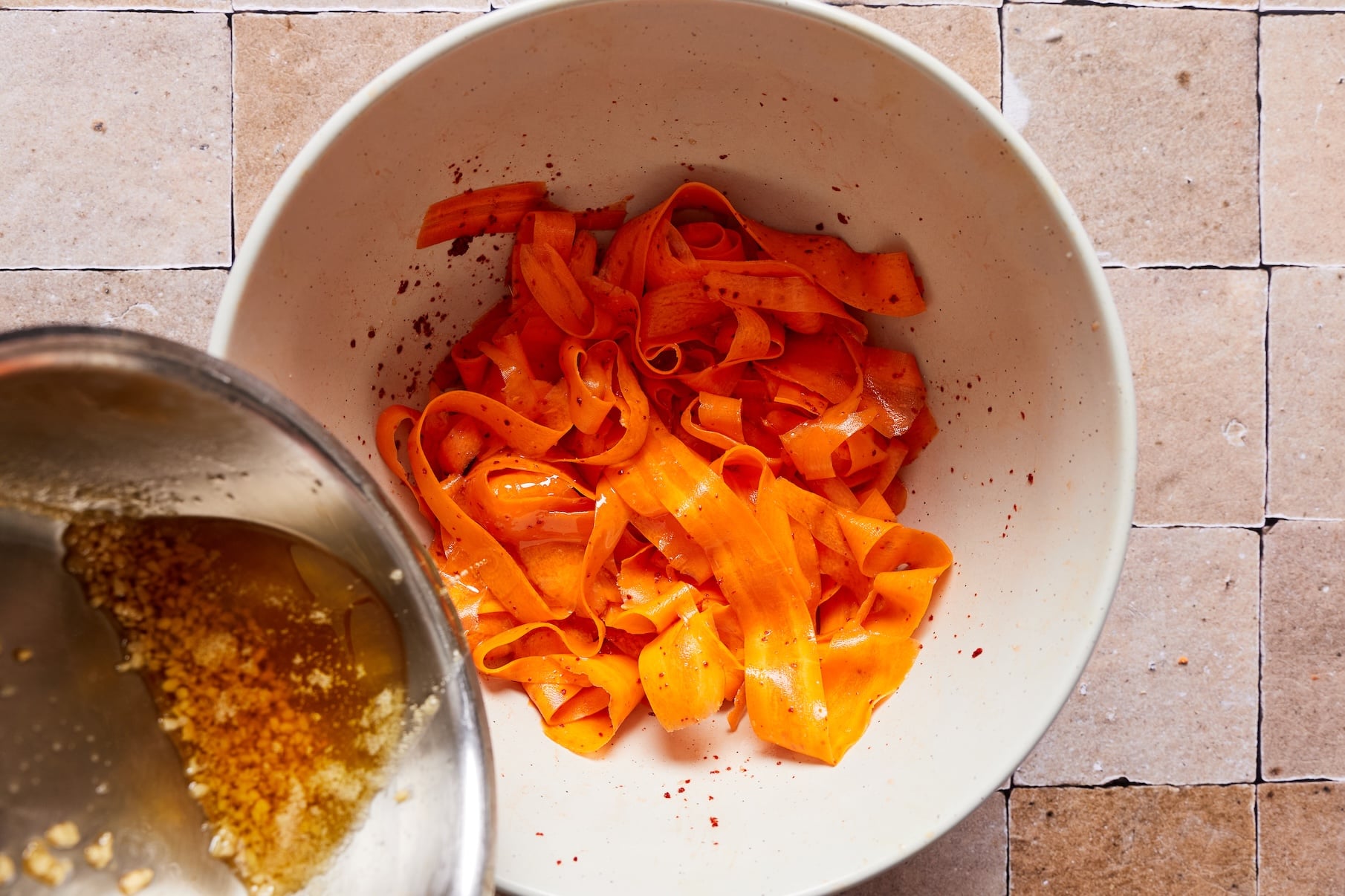Adding garlic oil over the carrot salad