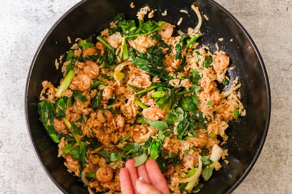 finishing the drunken fried rice with Thai basil.