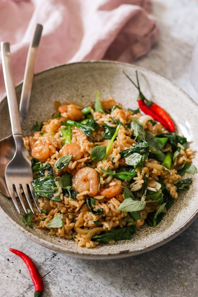 drunken fried rice in a bowl with a fork and a spoon. 
