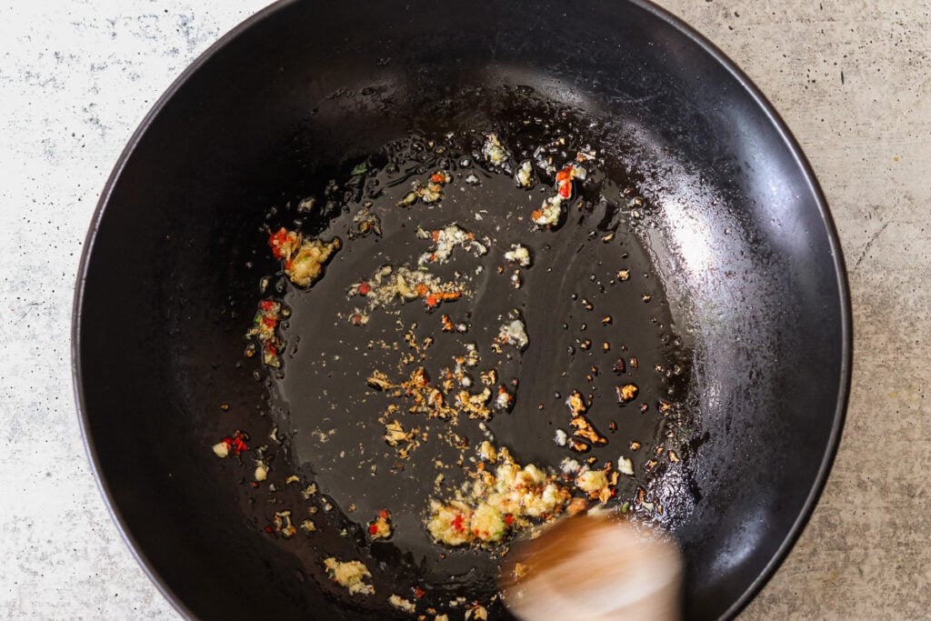sauteeing garlic in a wok