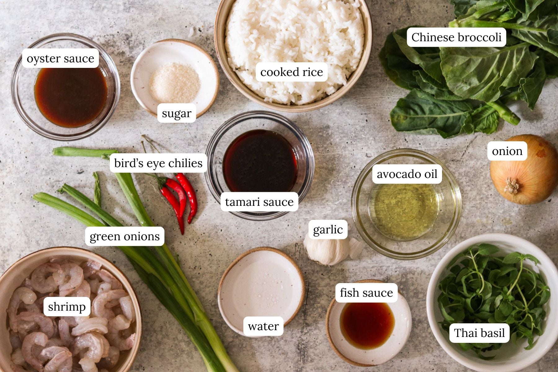 Flat lay of labeled ingredients for drunken fried rice on a speckled countertop.
