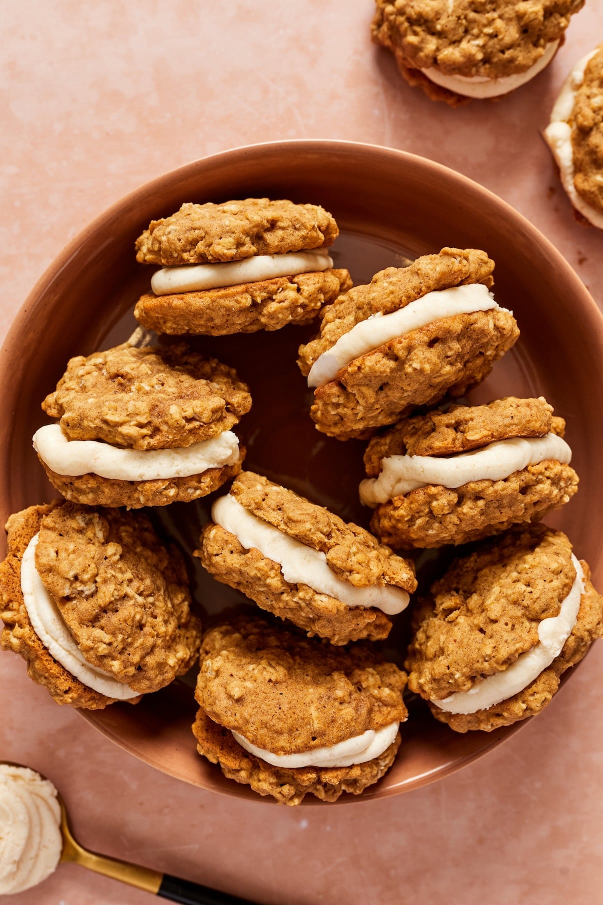 A bowl filled with gluten-free pumpkin oatmeal cream pies filled and sandwiched together.
