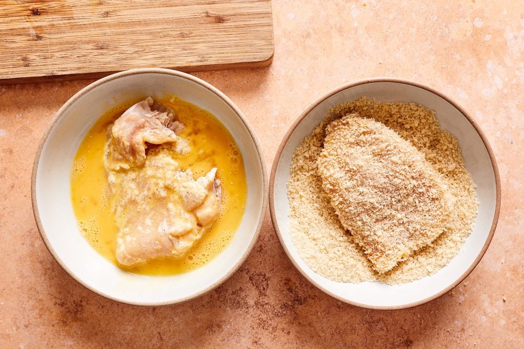 dredging chicken cutlets in egg, then pressing into a panko mixture.
